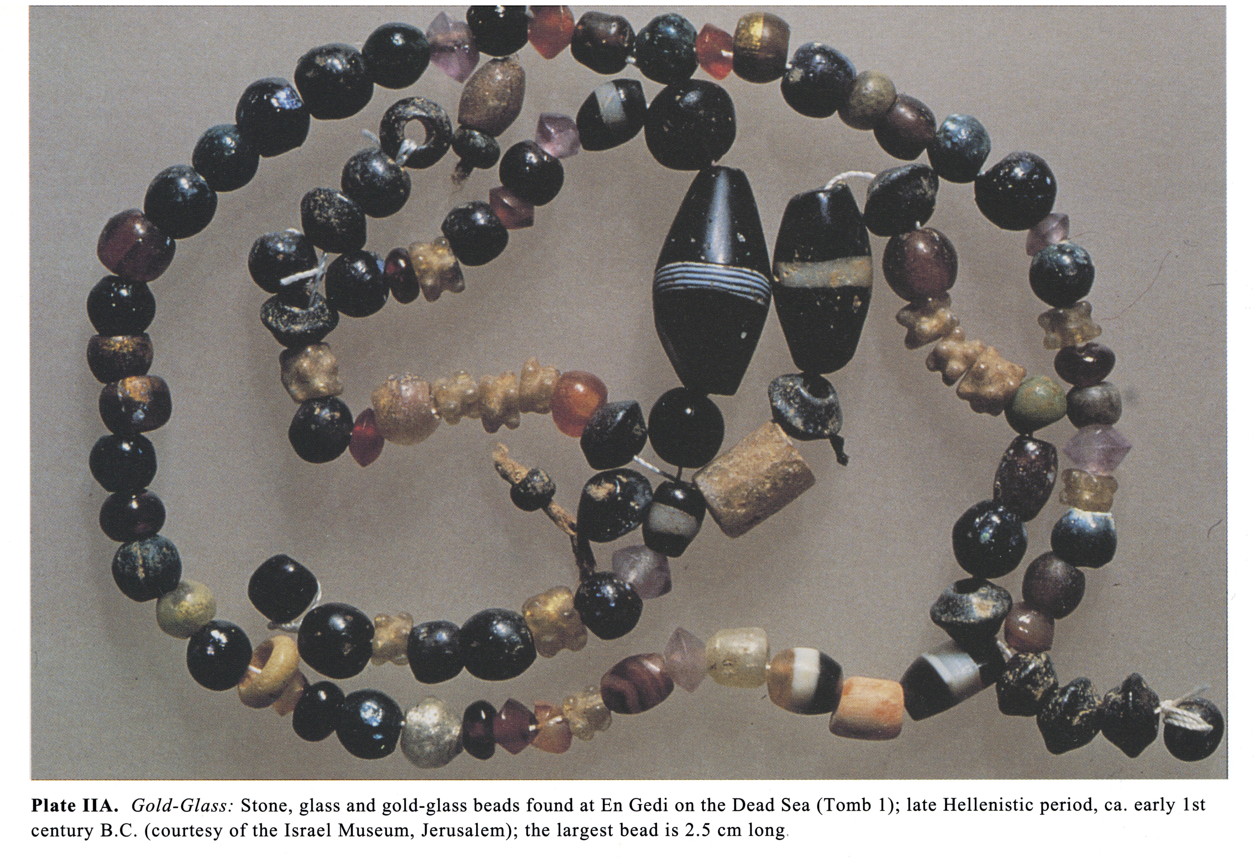 Plate IIA Gold-Glass: Stone, glass and gold-glass beads found at En Gedi on the Dead Sea (Tomb I); late Hellenistic period, ca. early 1st century B.C. (courtesy of the Israel Museum, Jerusalem); the largest bead is 2.5 cm long.