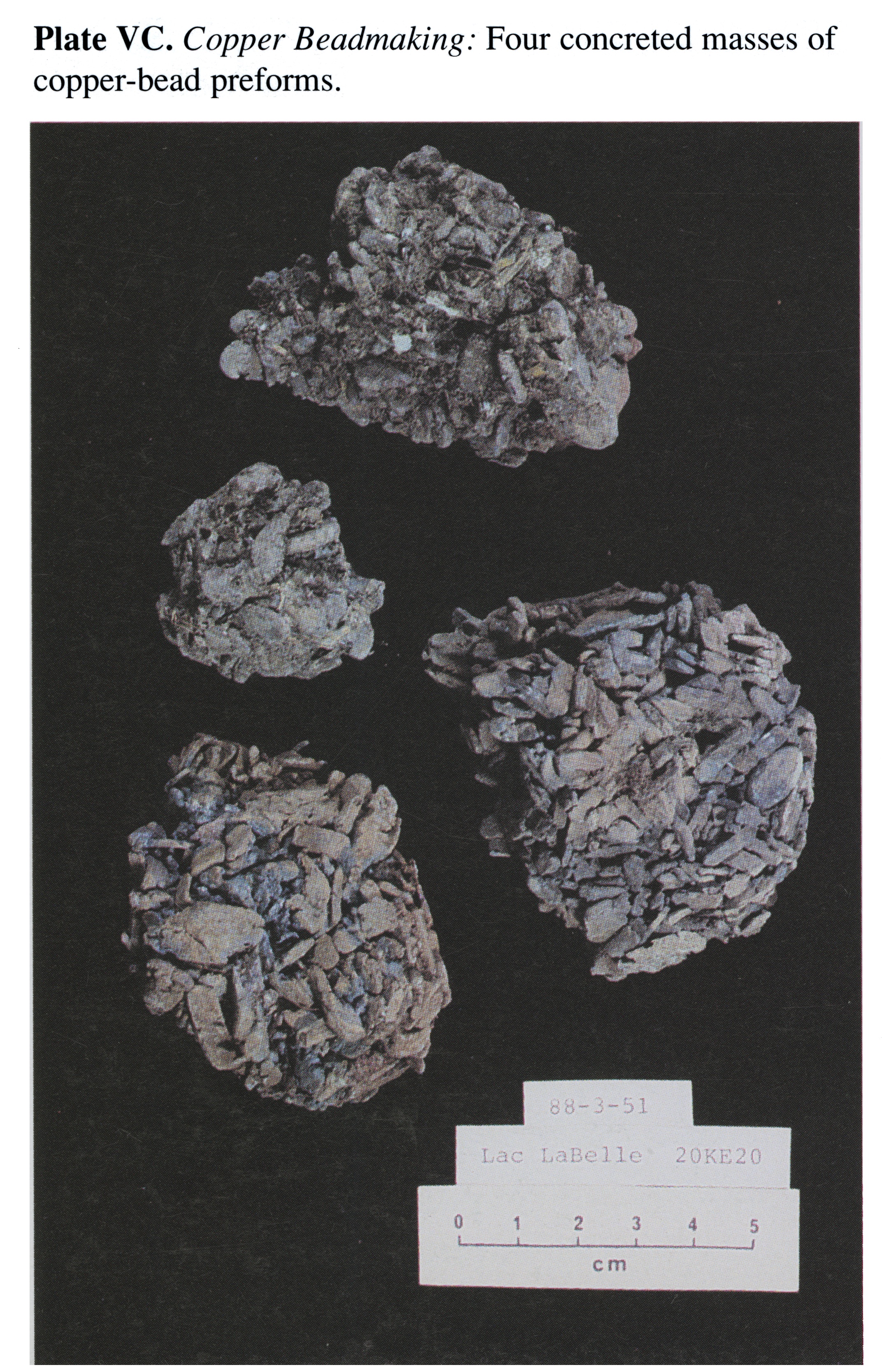 Plate VC Copper Beadmaking: Four concreted masses of copper-bead preforms.