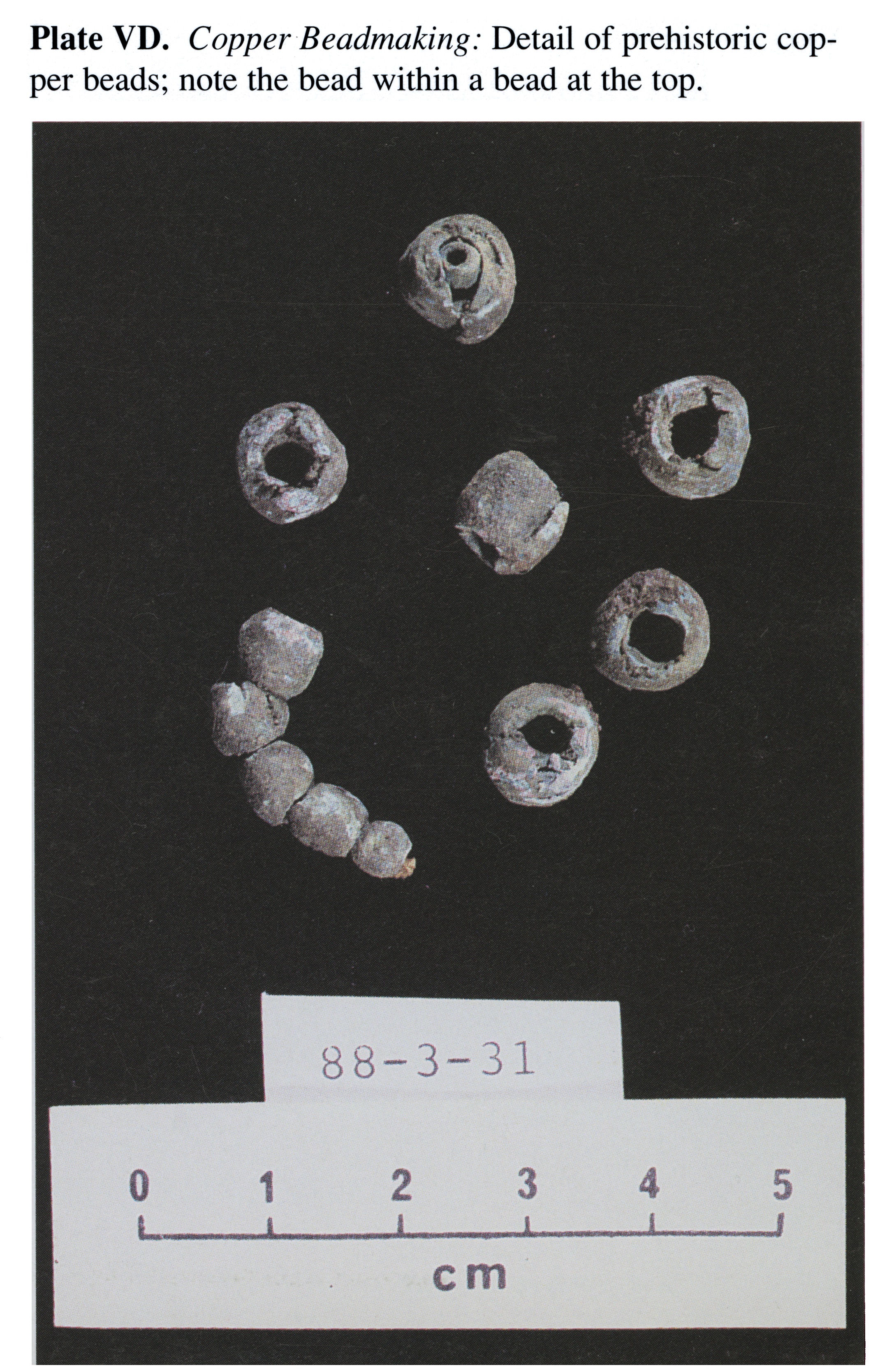 Plate VD Copper Beadmaking: Detail of prehistoric copper beads; note the bead within a bead at the top. 