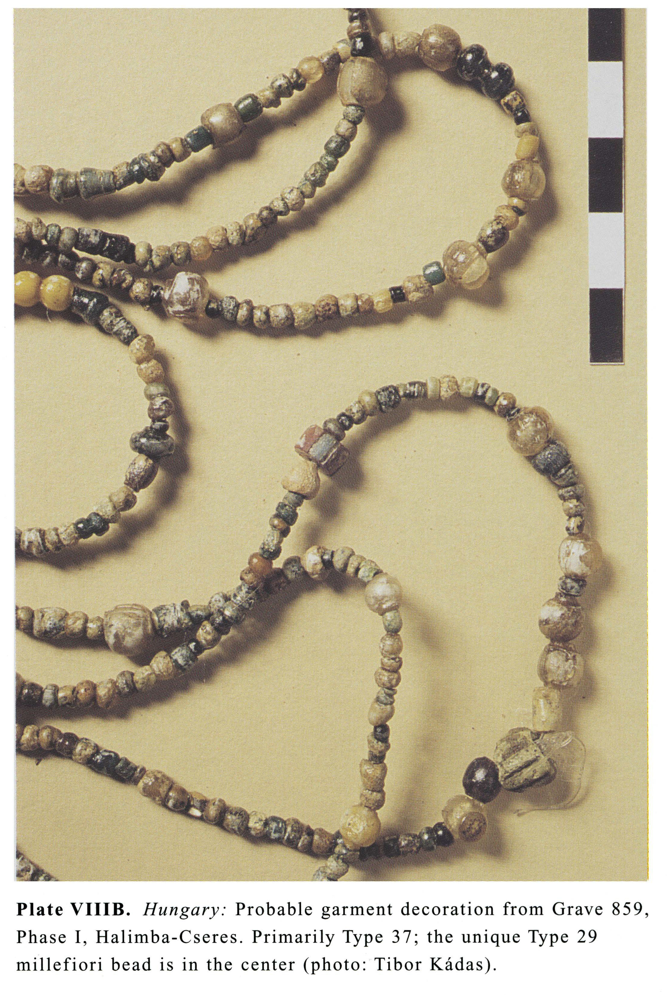 Plate VIIIB Hungary: Probable garment decoration from Grave 859, Phase I, Halimba-Cseres. Primarily Type 37; the unique Type 29 millefiori bead is in the center (photo: Tibor Kadas).