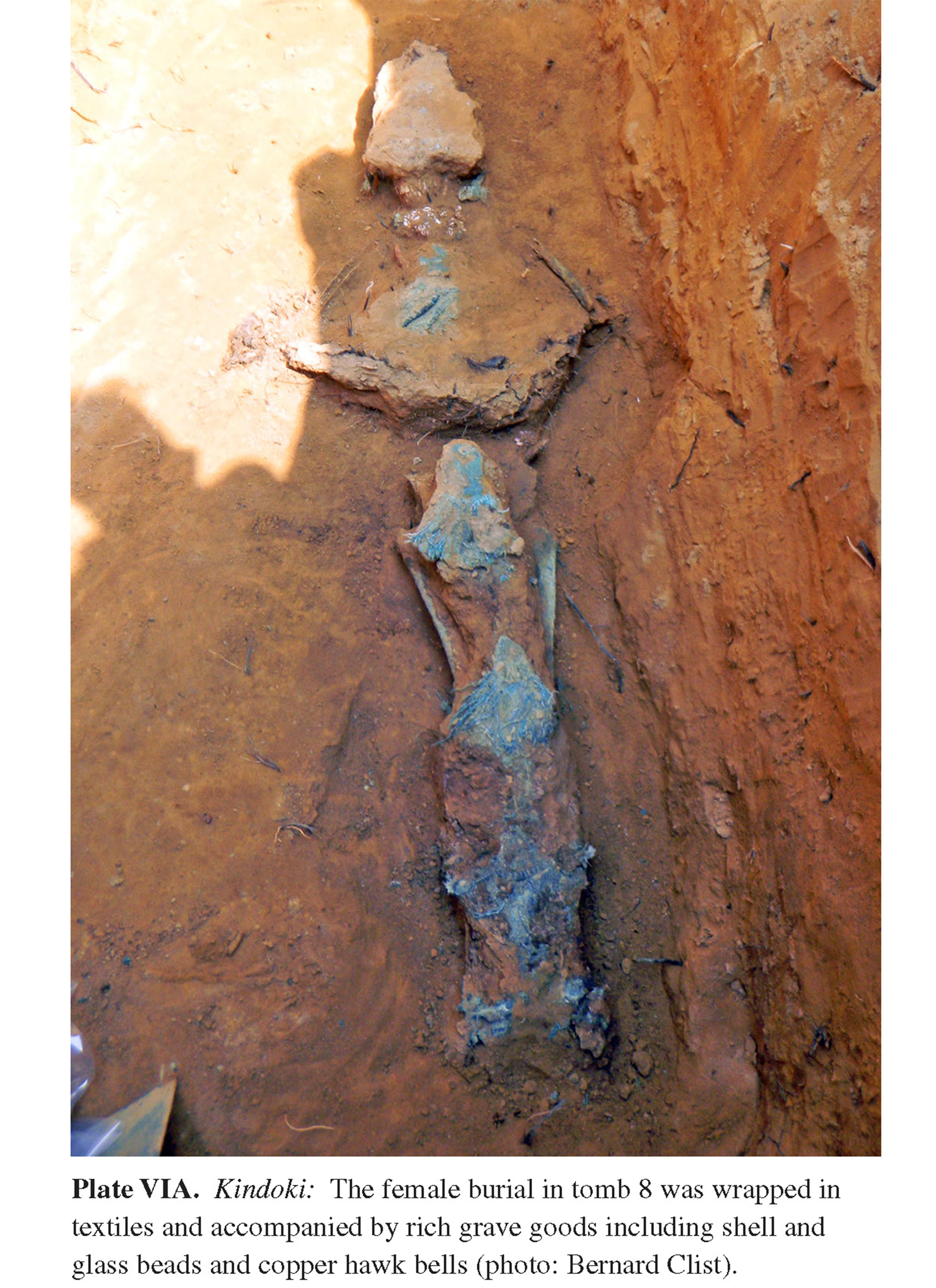 Plate VIA Kindoki: The female burial in tomb 8 was wrapped in textiles and accompanied by rich grave goods including shell and glass beads and copper hawk bells (photo: Bernard Clist).