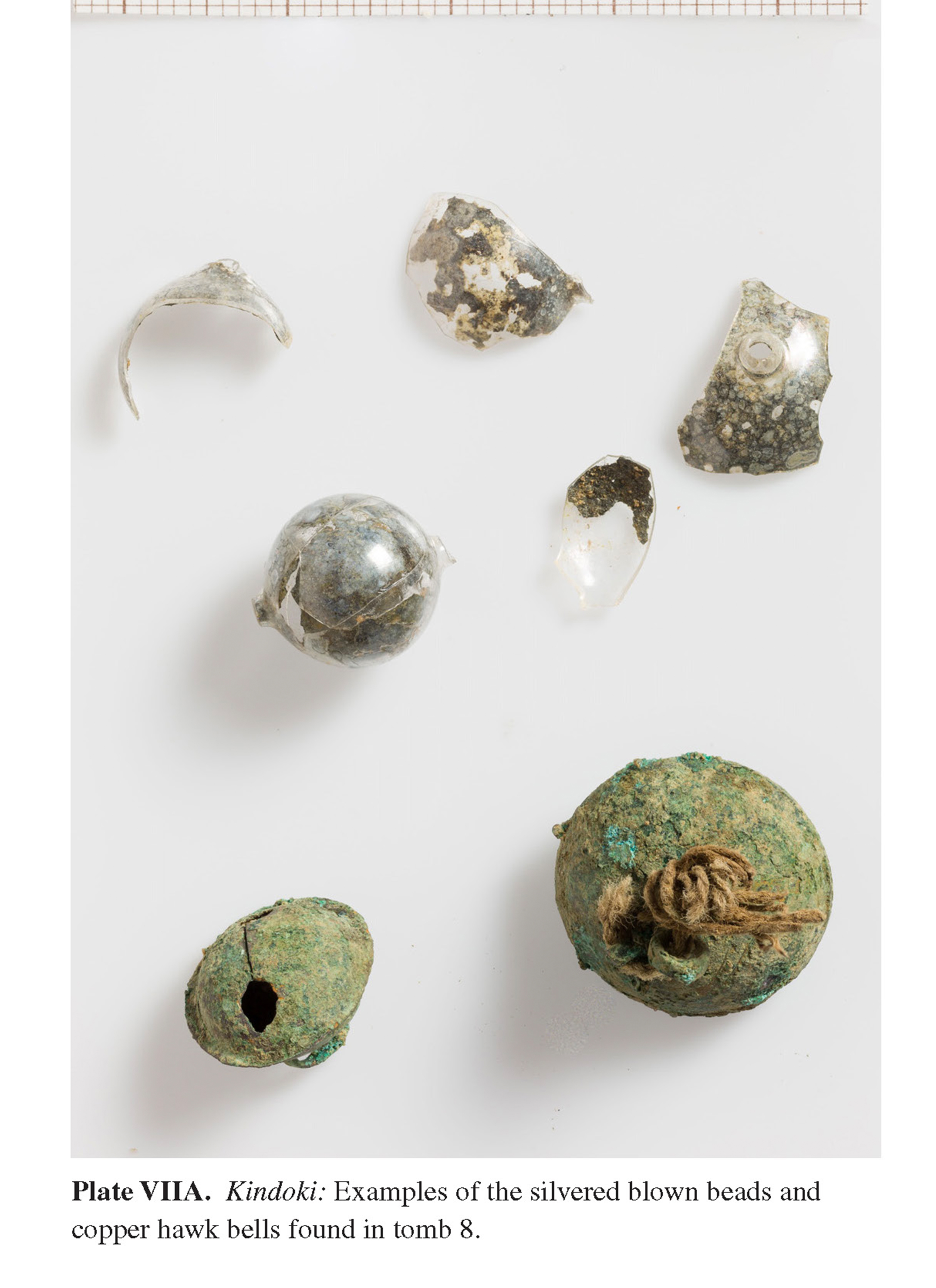 Plate VIIA Kindoki: Examples of the silvered blown beads and copper hawk bells found in tomb 8.