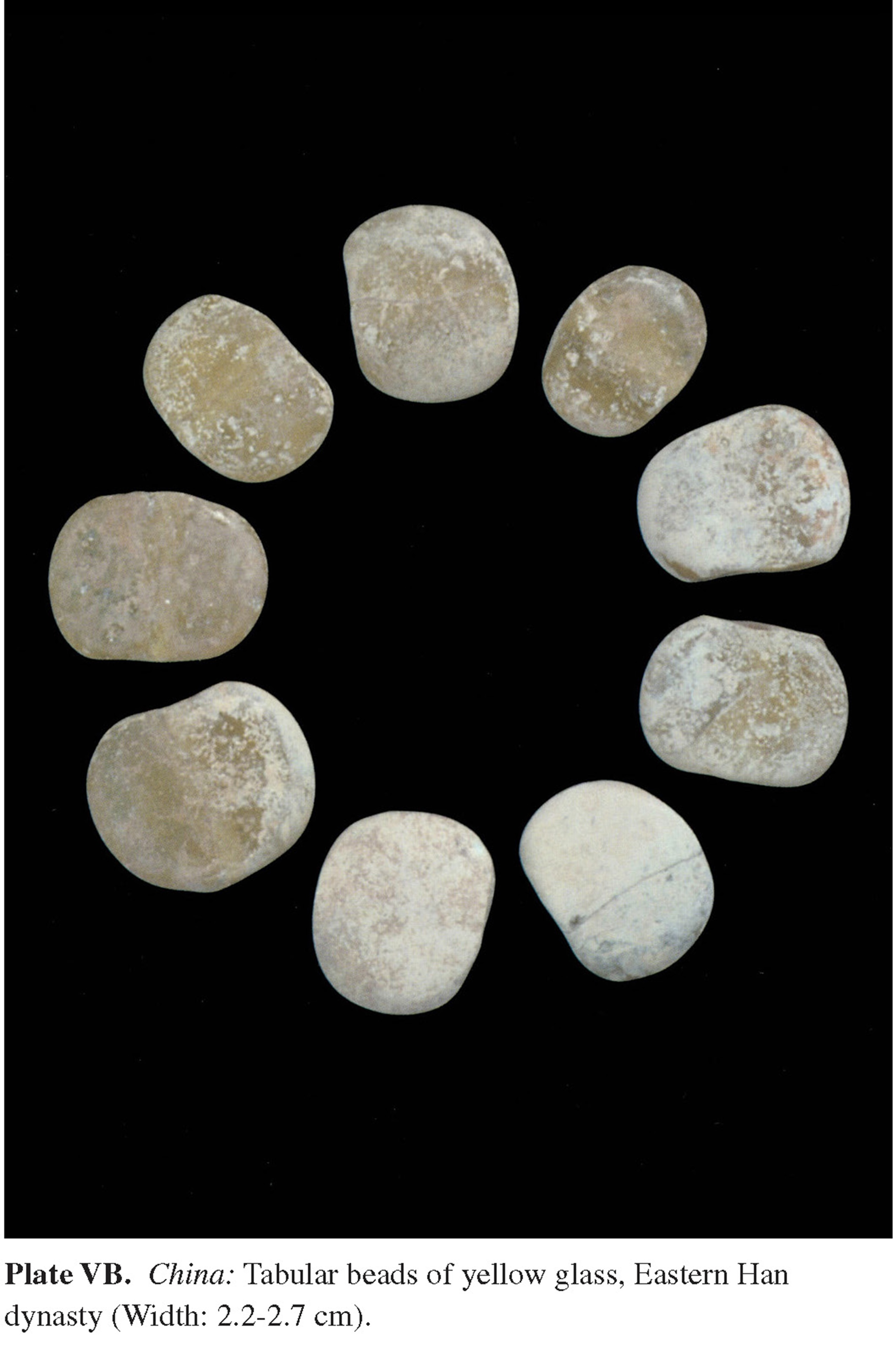 Plate VB China: Tabular beads of yellow glass, Eastern Han dynasty (Width: 2.2-2.7 cm).