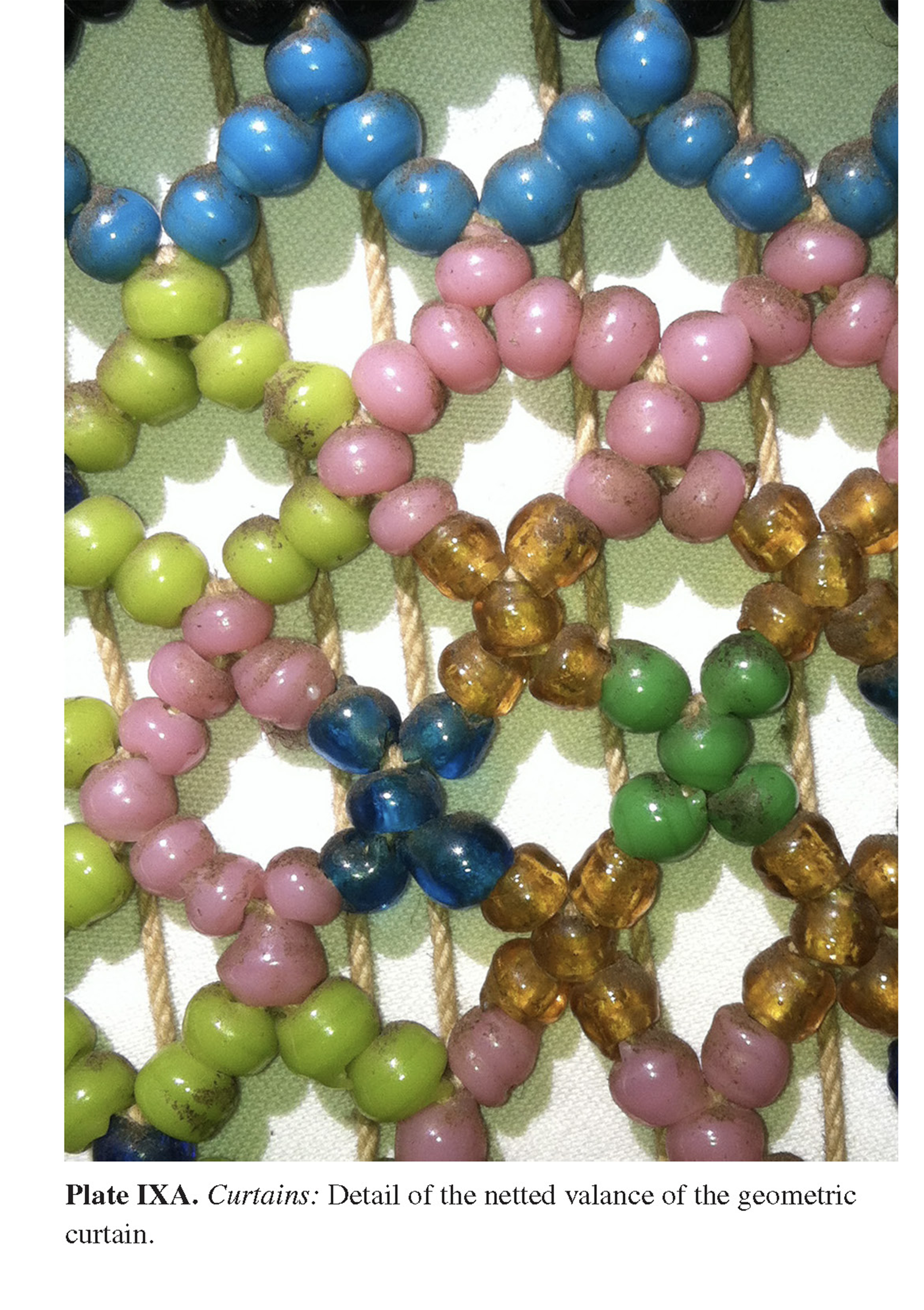 Plate IXA Curtains: Detail of the netted valance of the geometric curtain.