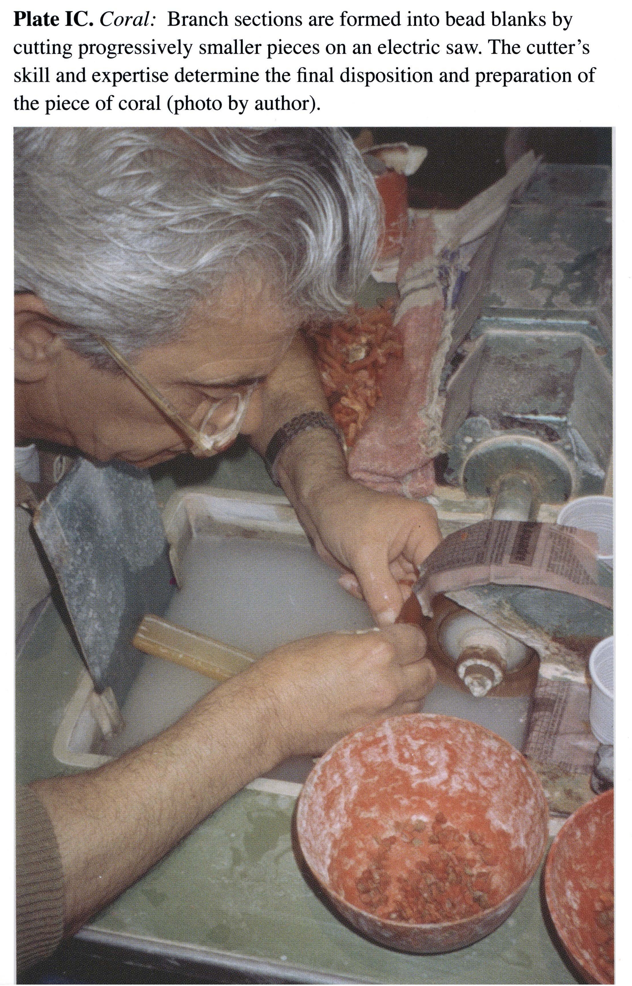Plate IC Coral: Branch sections are formed into bead blanks by cutting progressively smaller pieces on an electric saw. The cutter's skill and expertise determine the final disposition and preparation of the piece of coral (photo by author).