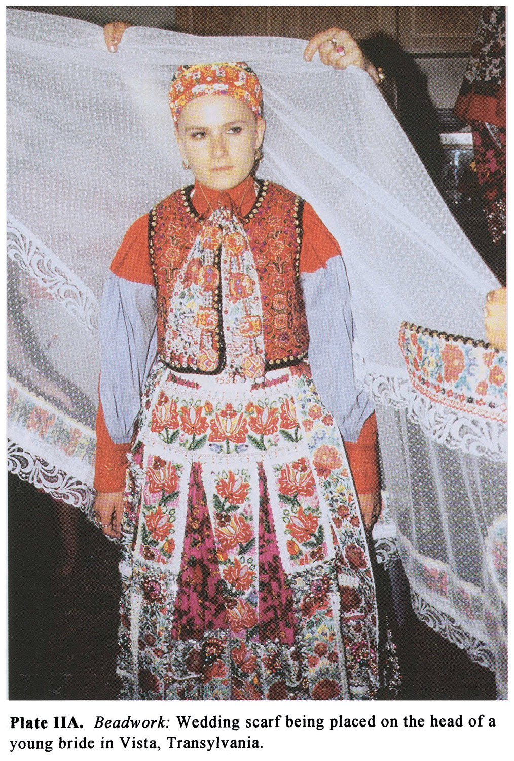 Plate IIA Beadwork: Wedding scarf being placed on the head of a young bride in Vista, Transylvania.