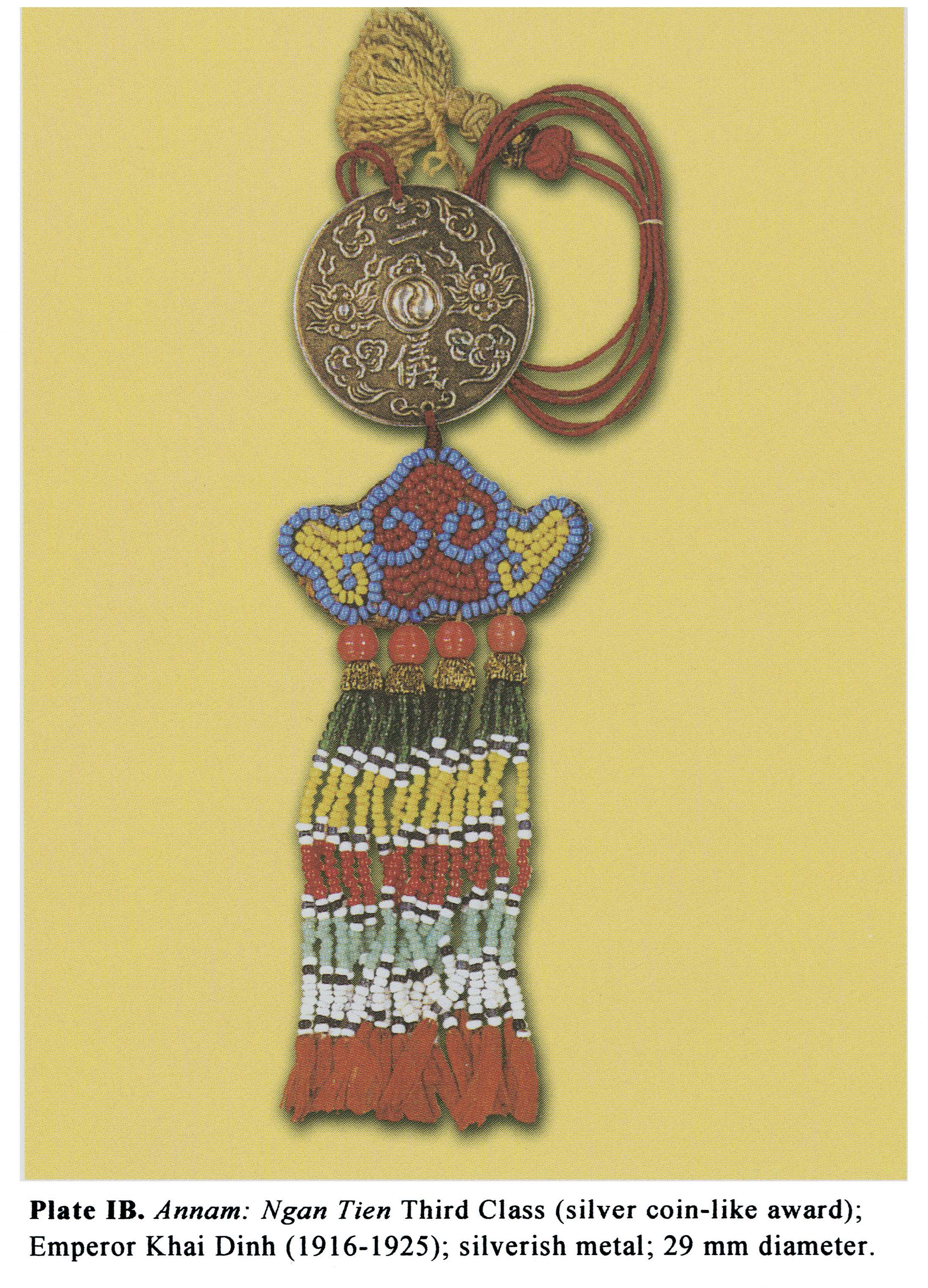 Plate IB Annam: Ngan Tien Third Class (silver coin-like award); Emperor Khai Dinh (1916-1925); silverish metal; 29 mm diameter.
