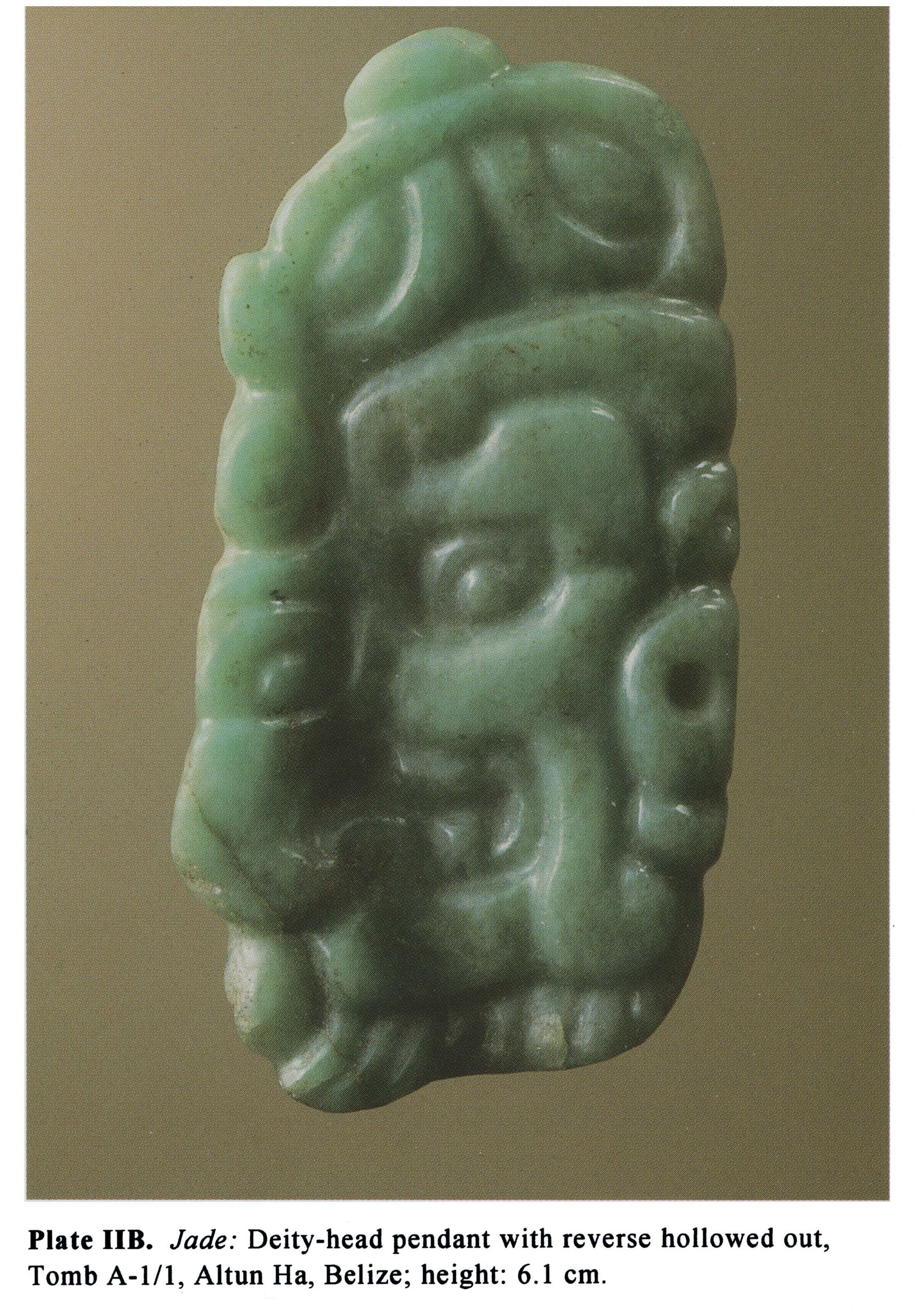 Plate IIB Jade: Deity-head pendant with reverse hollowed out, Tomb A-1/1, Altun Ha, Belize; height: 6.1 cm.
