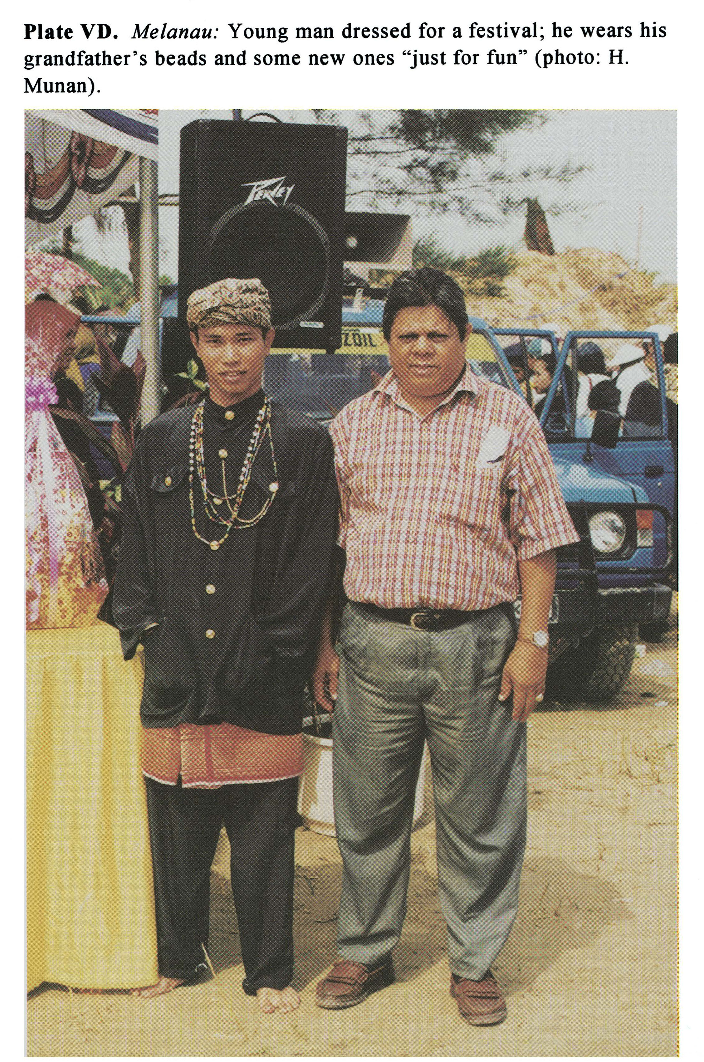 Plate VD Melanau: Young man dressed for a festival; he wears his grandfather's beads and some new ones 