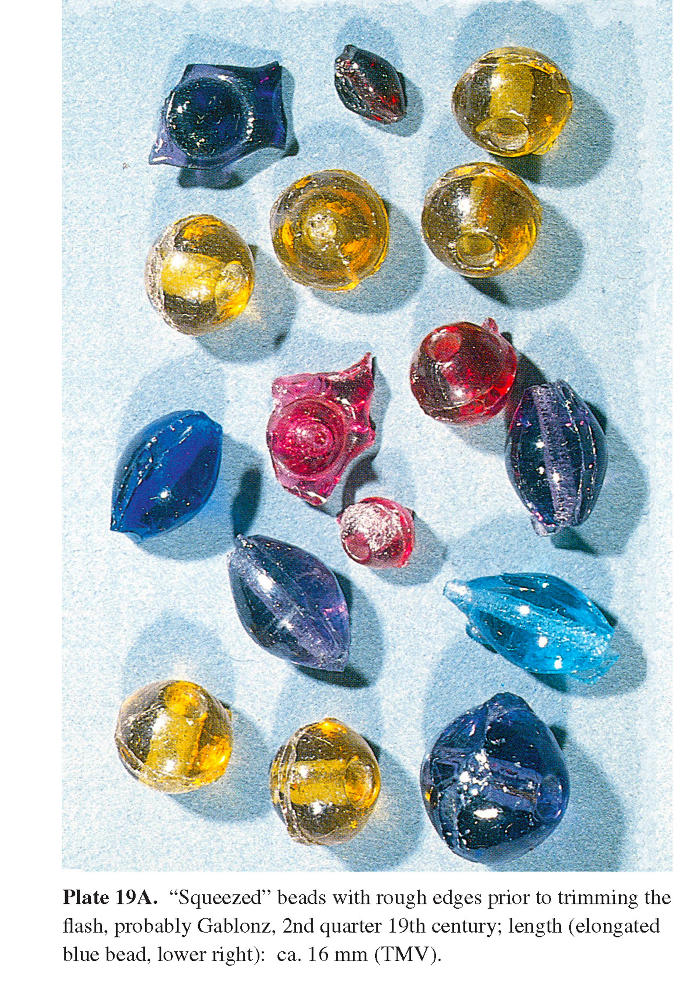 Plate 19A “Squeezed” beads with rough edges prior to trimming the flash, probably Gablonz, 2nd quarter 19th century; length (elongated blue bead, lower right): ca. 16 mm (TMV).